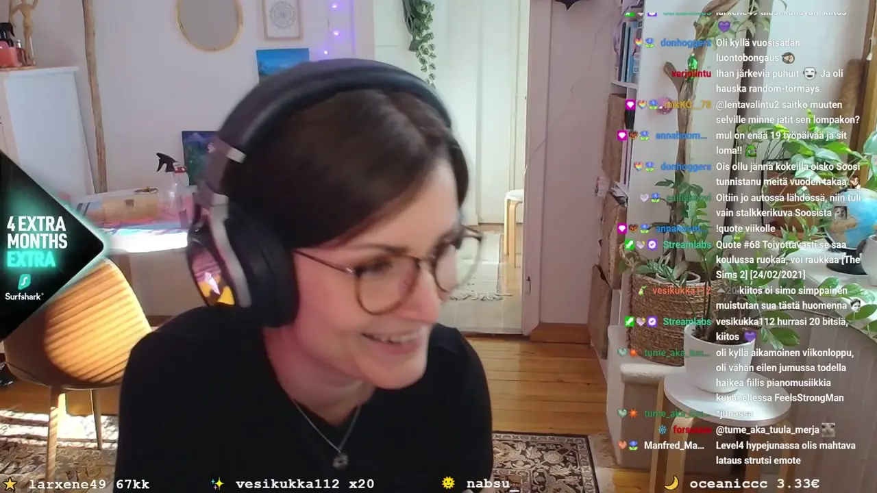 Creator wearing headphones on a Just Chatting stream with the Surfshark overlay on the left and a busy chat on the right